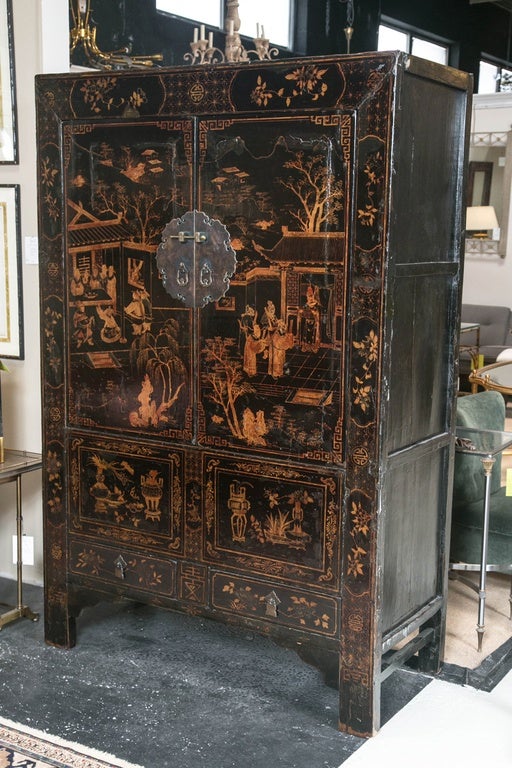 Two-door over two-drawer hardwood lacquered armoire, Chinese, 20th century.