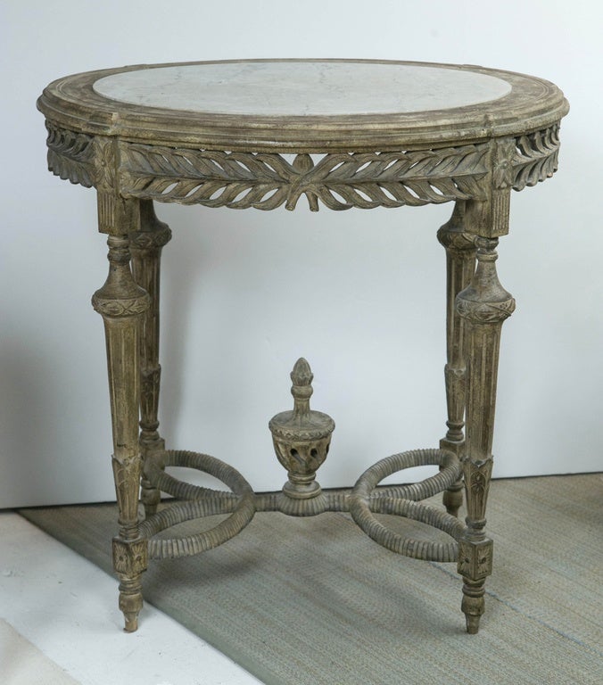 Swedish wood and white marble oval center table, with twisted leg and ornate trophy.