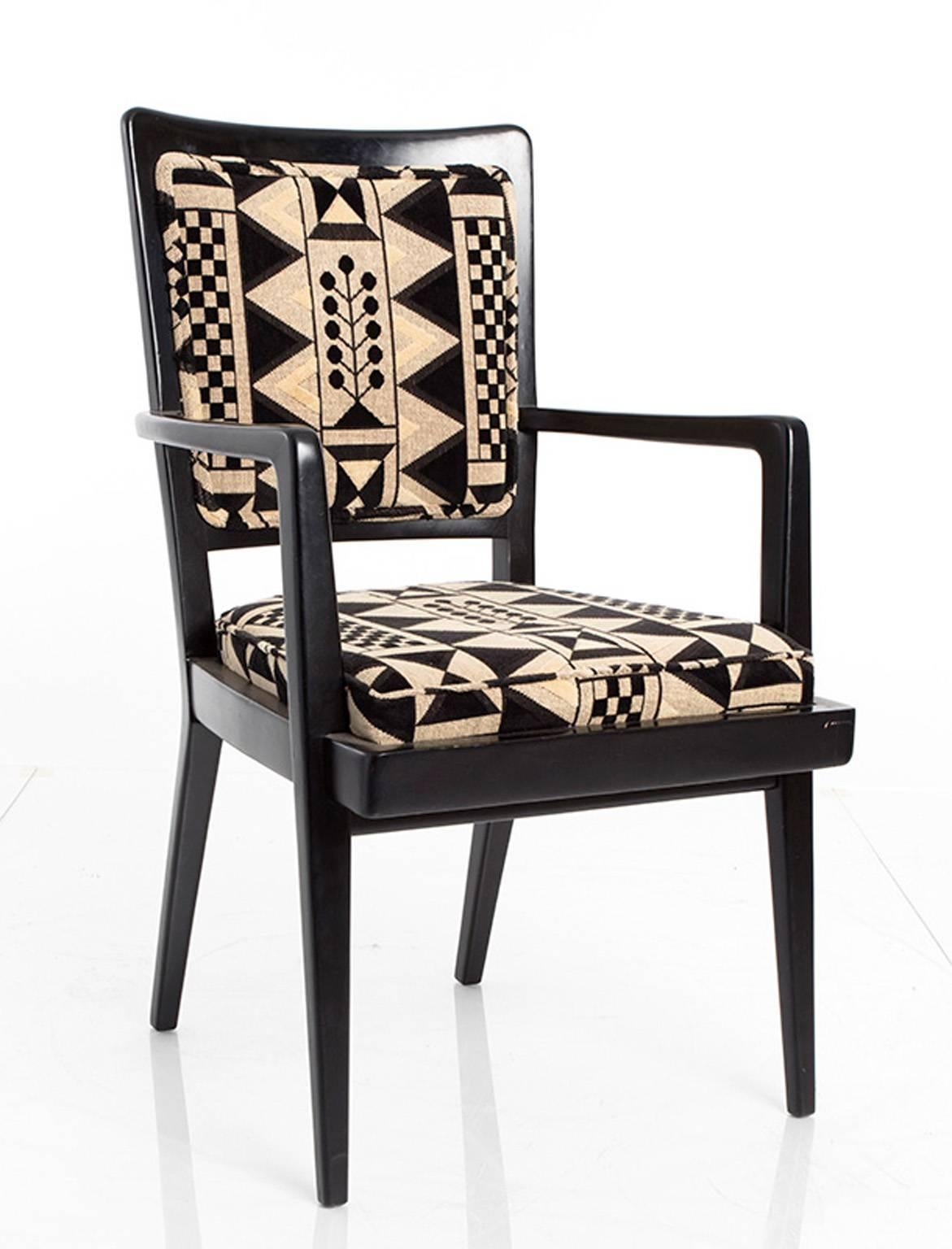 Set of six Art Deco armchairs. The frames are ebonized and the chairs upholstered in a geometric patterned fabric.
  