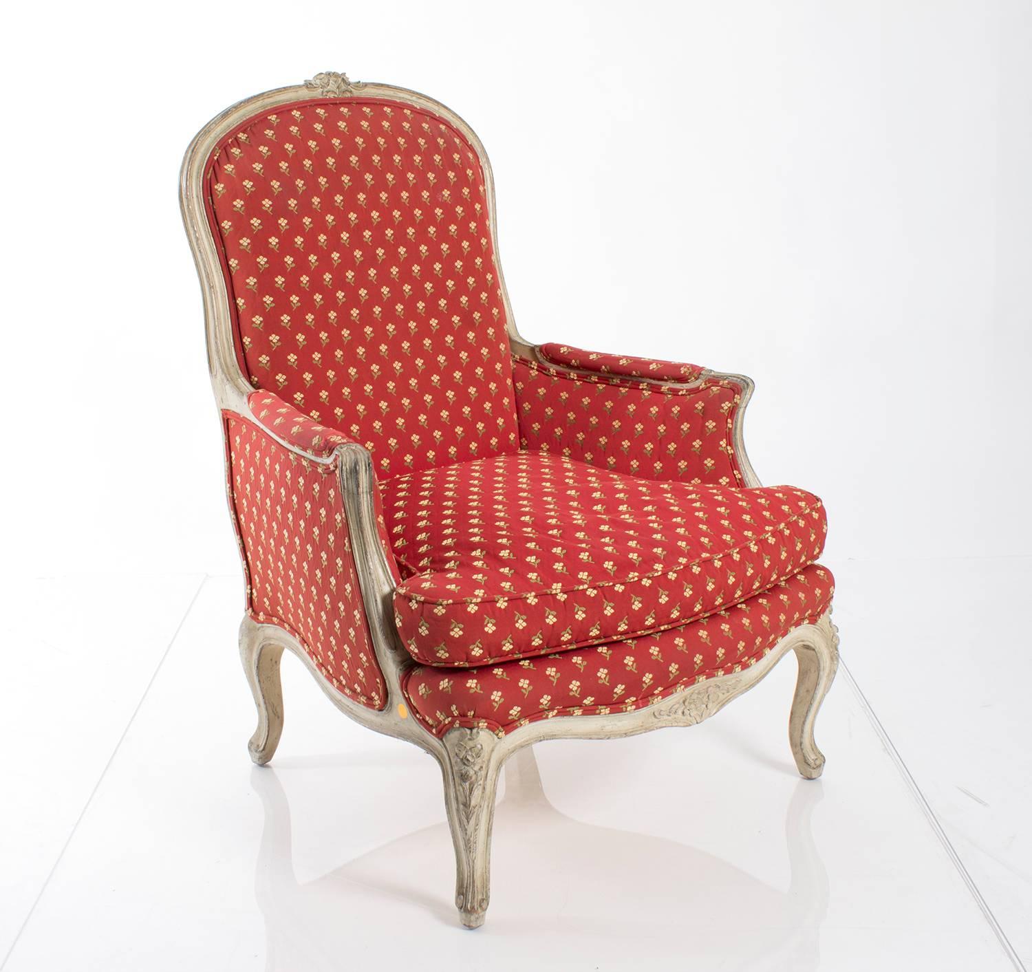 Pair of French bergères upholstered in a red and yellow floral print fabric.
 