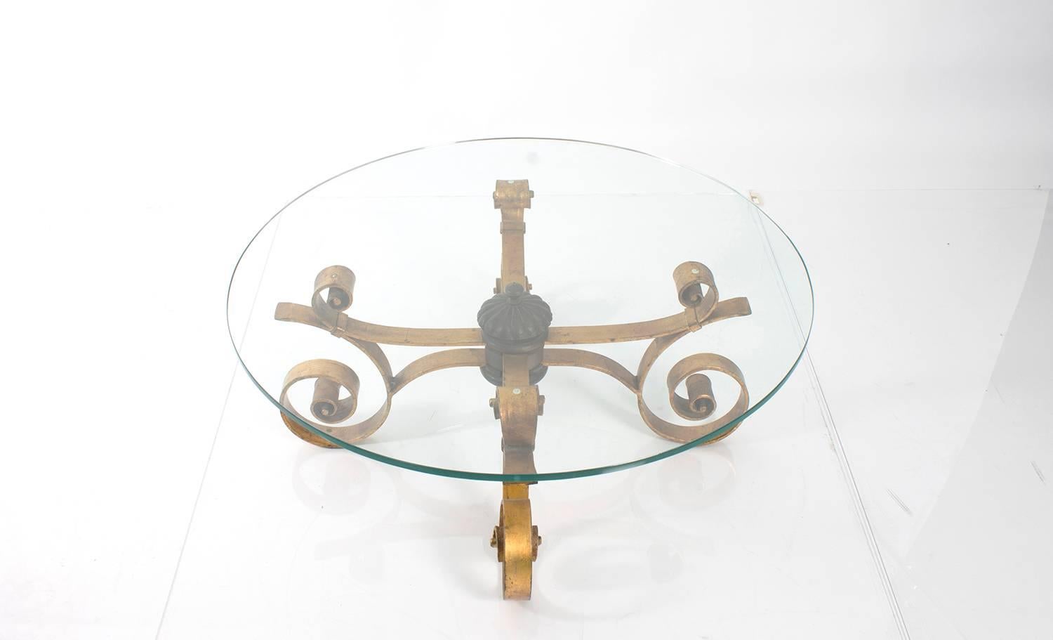 Scroll-leg wrought iron low table. Glass-topped.