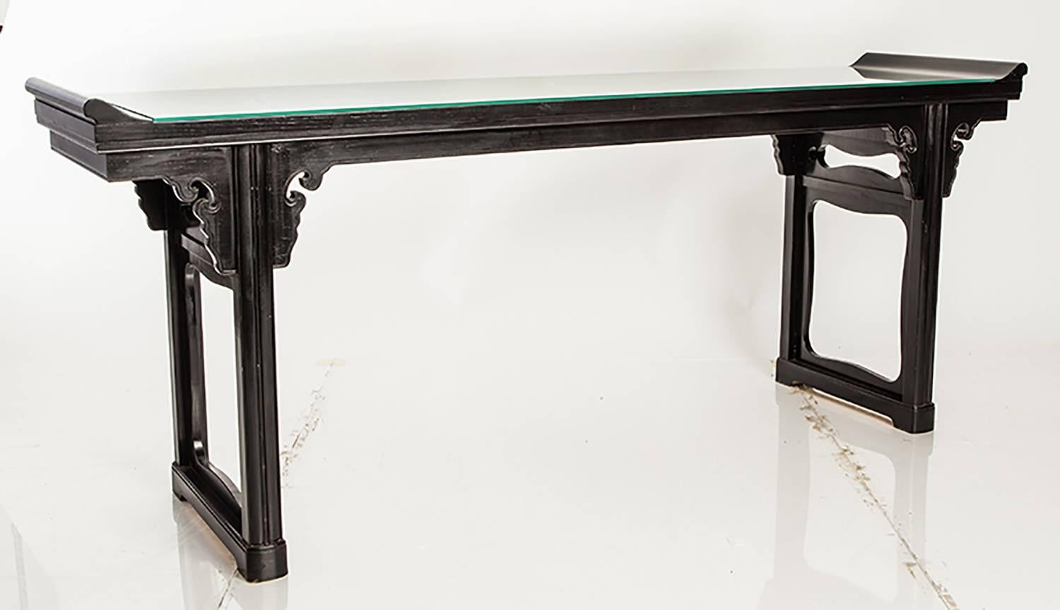 Black lacquer console table in the style of a traditional Asian altar table.