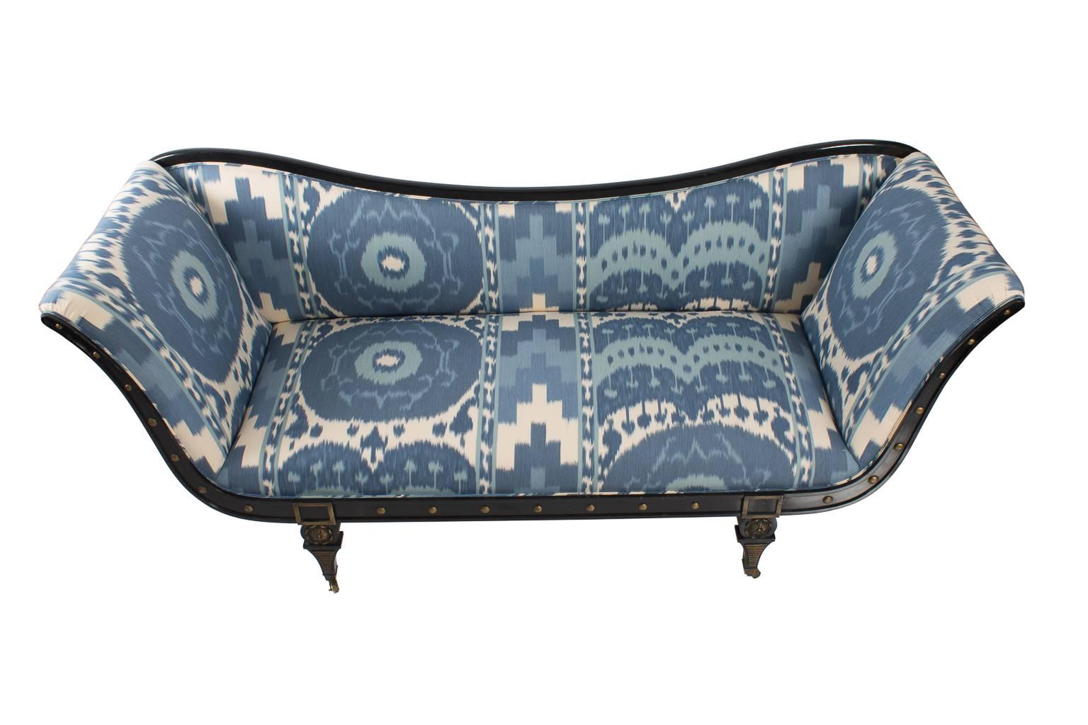 Hollywood Regency style sofa with an ebonized frame and ikat inspired fabric.