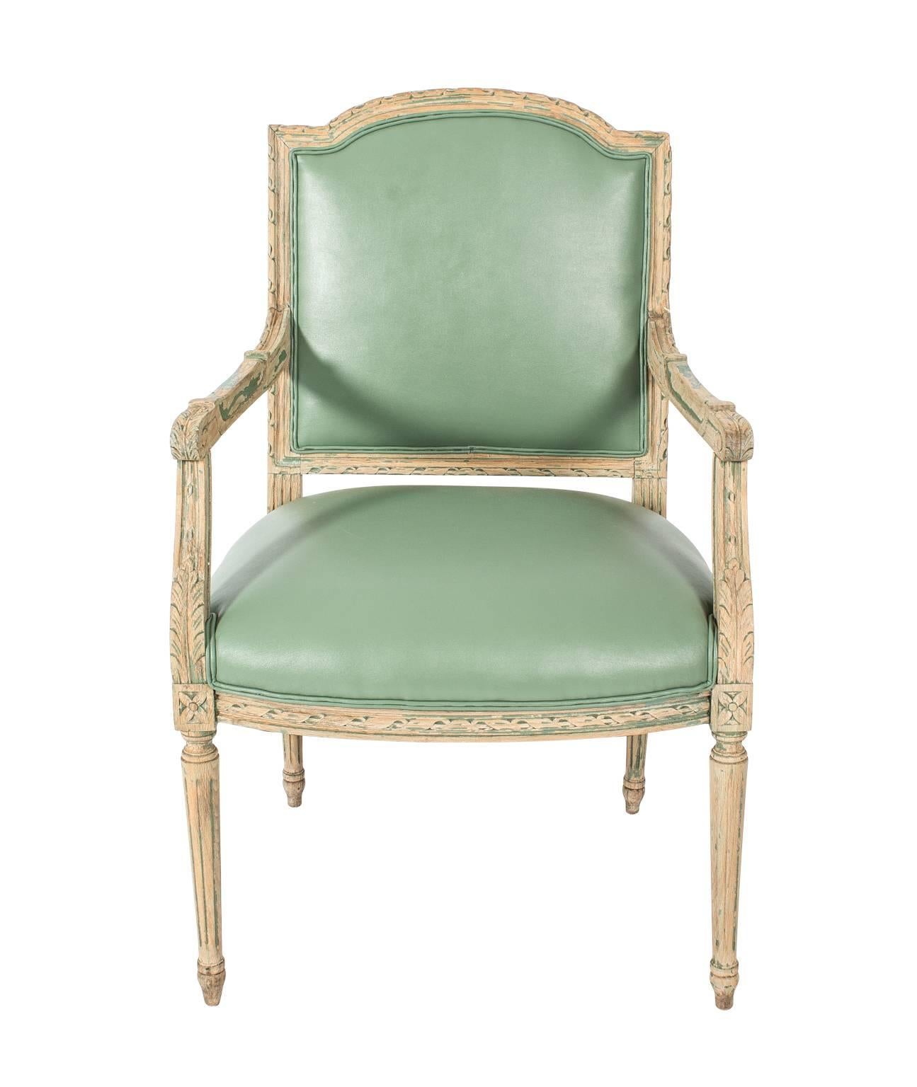 Pair of mint green leather armchairs. Distressed and painted frames.