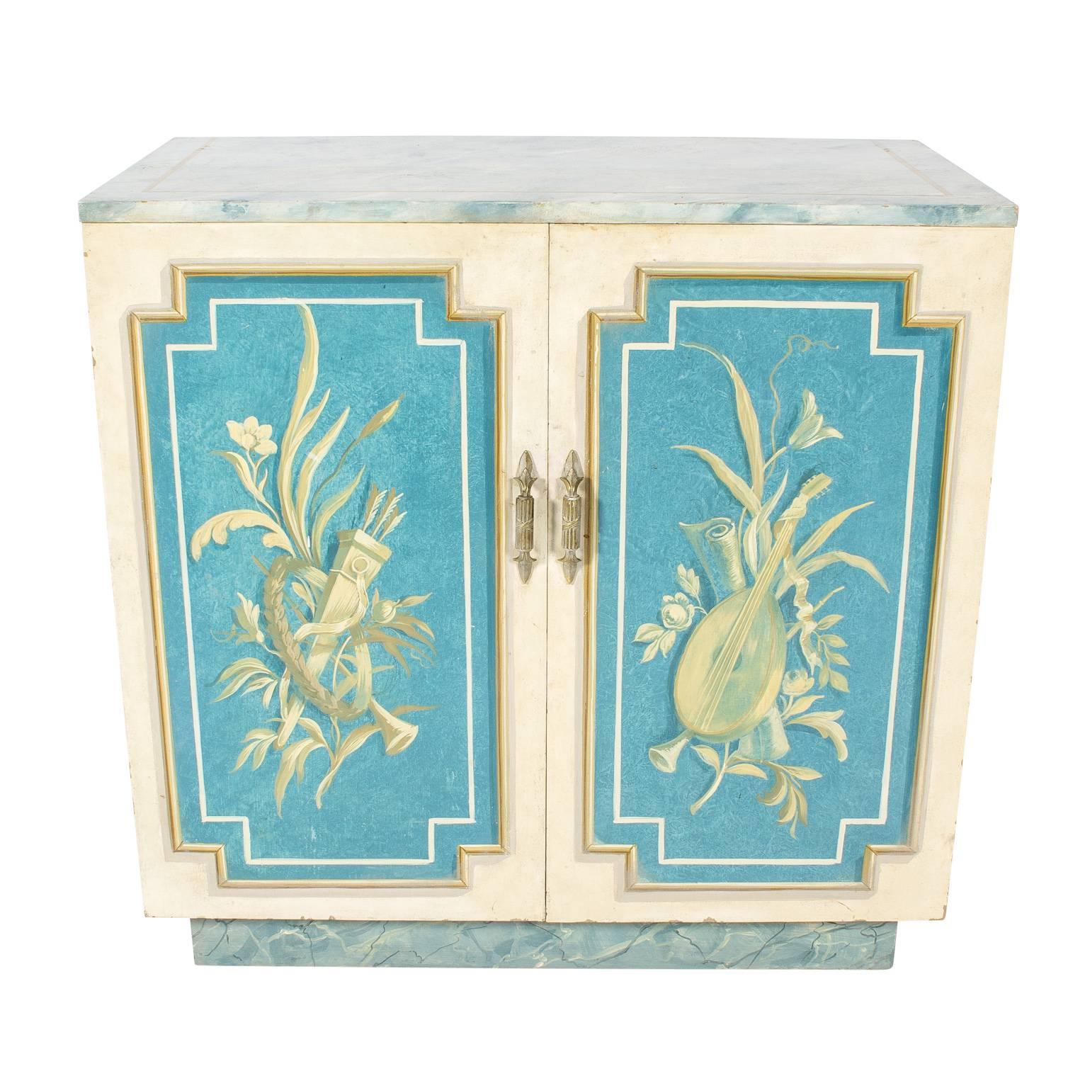 Pair of blue and white faux painted cabinets with music and flora motifs painted throughout.