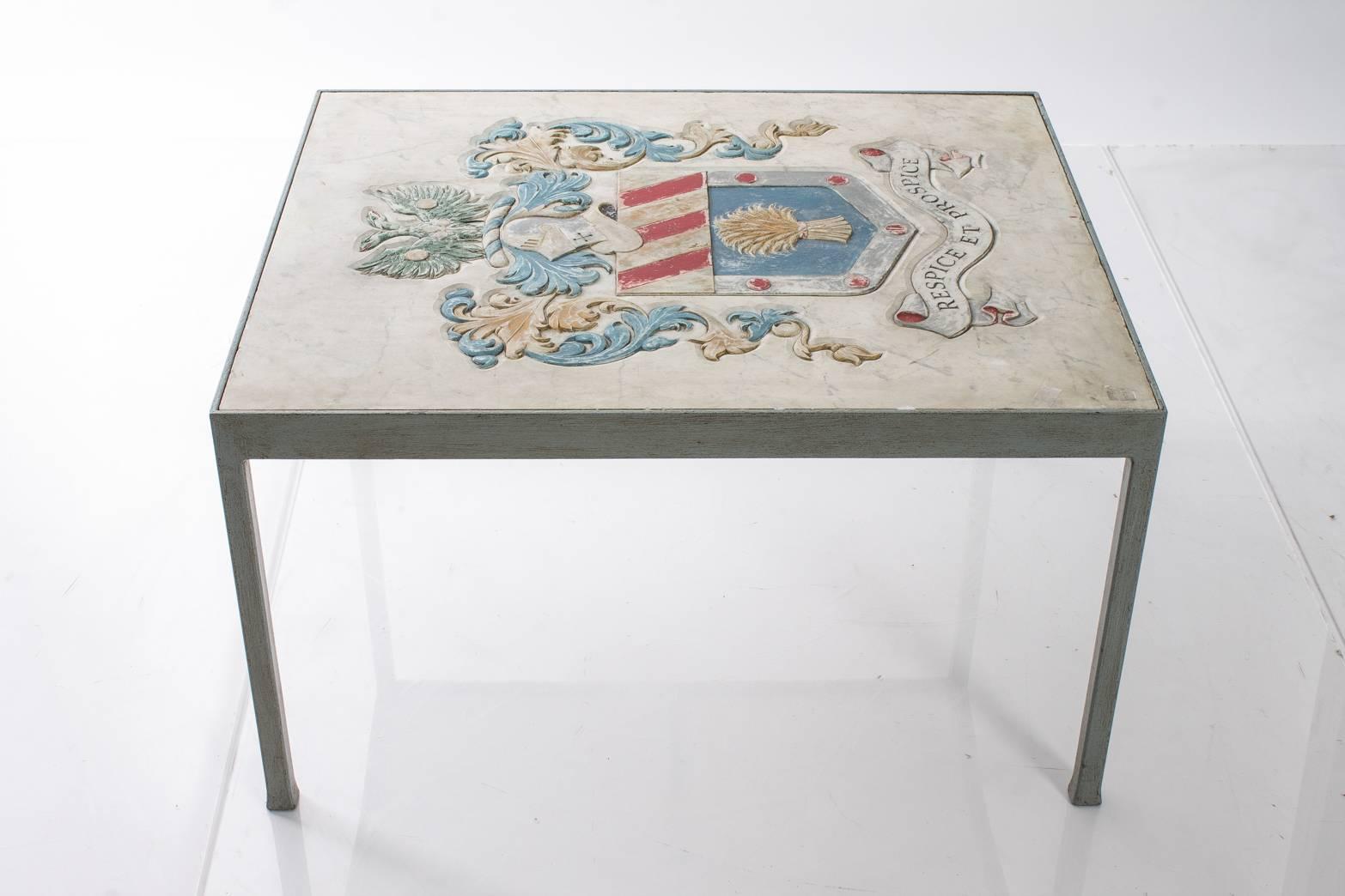 Table with a carved marble plaque top depicting a heraldic crest. The plaque had previously hung over a fireplace in Sussex, circa 1870.