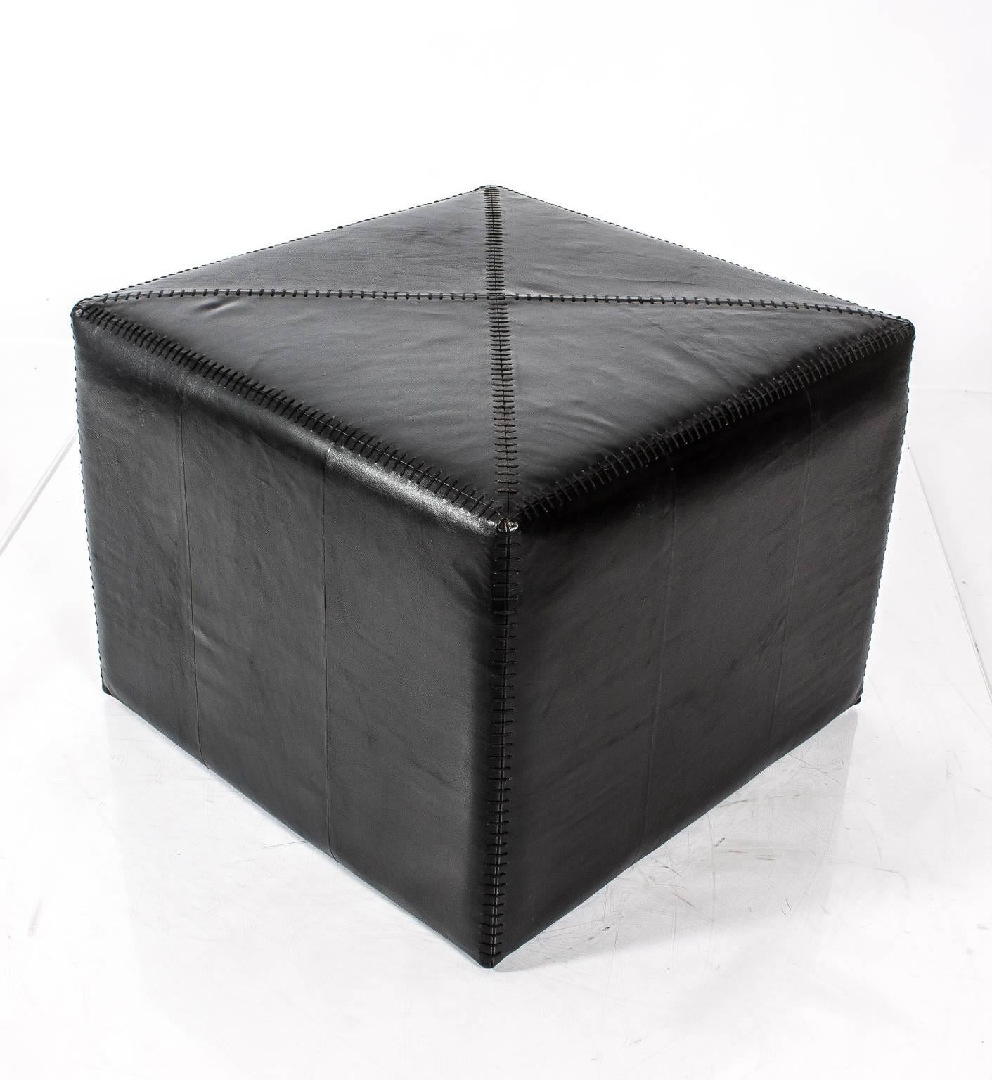 Square black leather stool/ottoman with top stitching.