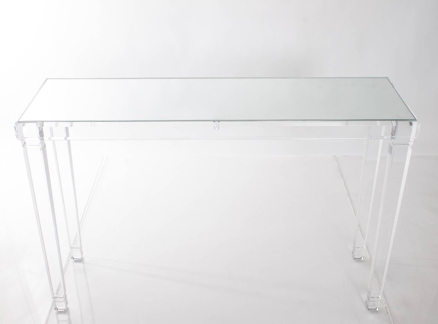 Custom Lucite table with mirrored top and elegant tapered legs. Perfect for an entryway or as a sofa table.