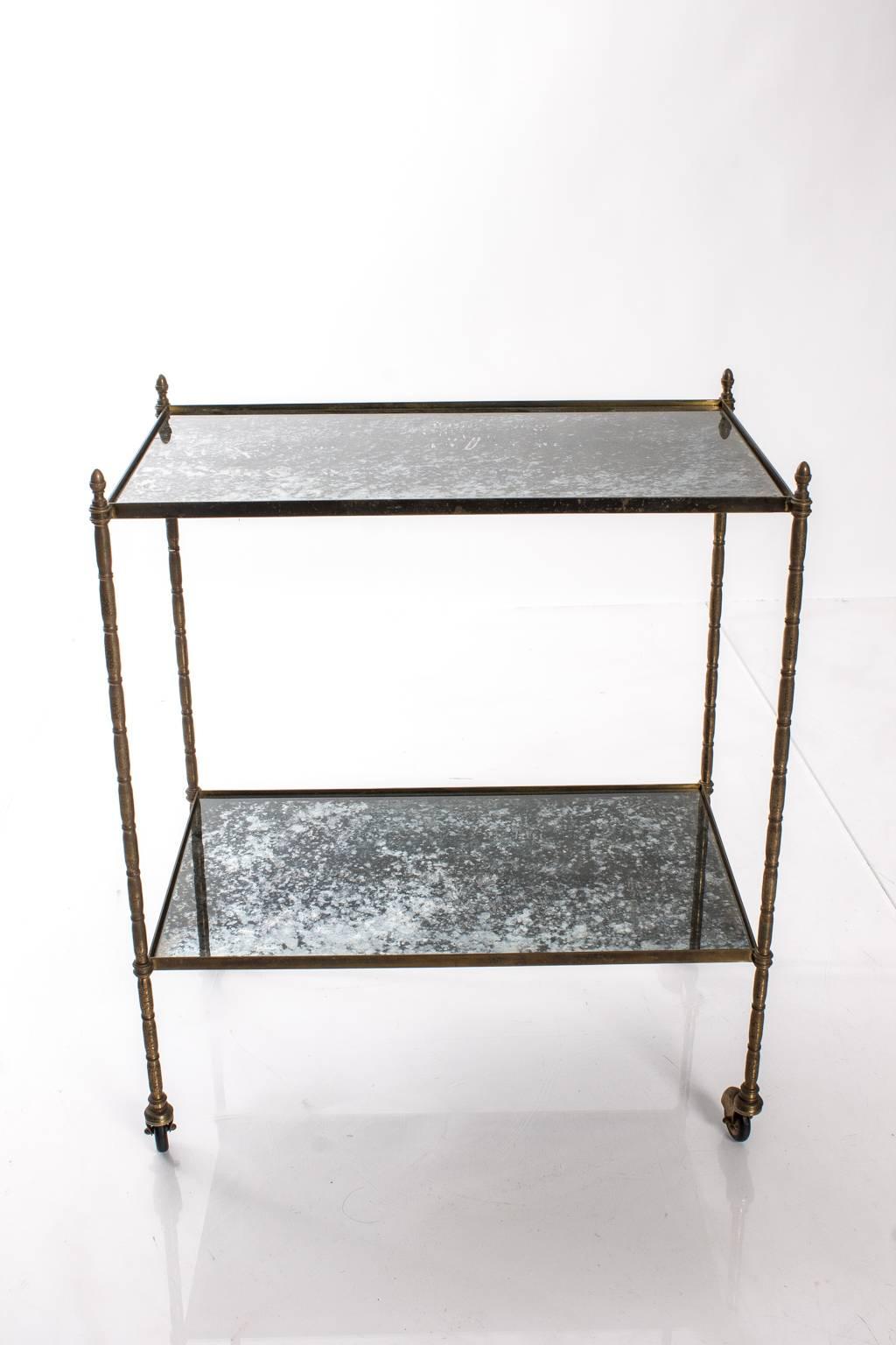 Vintage French two-tier cart in brass with mirrored shelves.
 