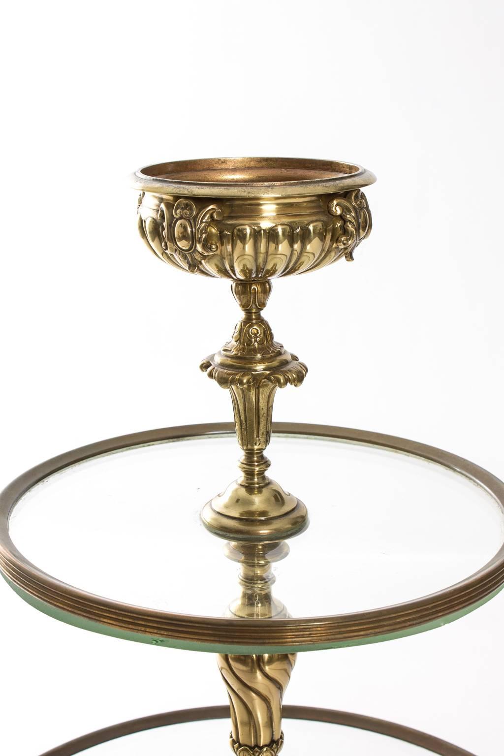 19th century three-tier round glass and brass display stand. Cast bronze with floral accents.