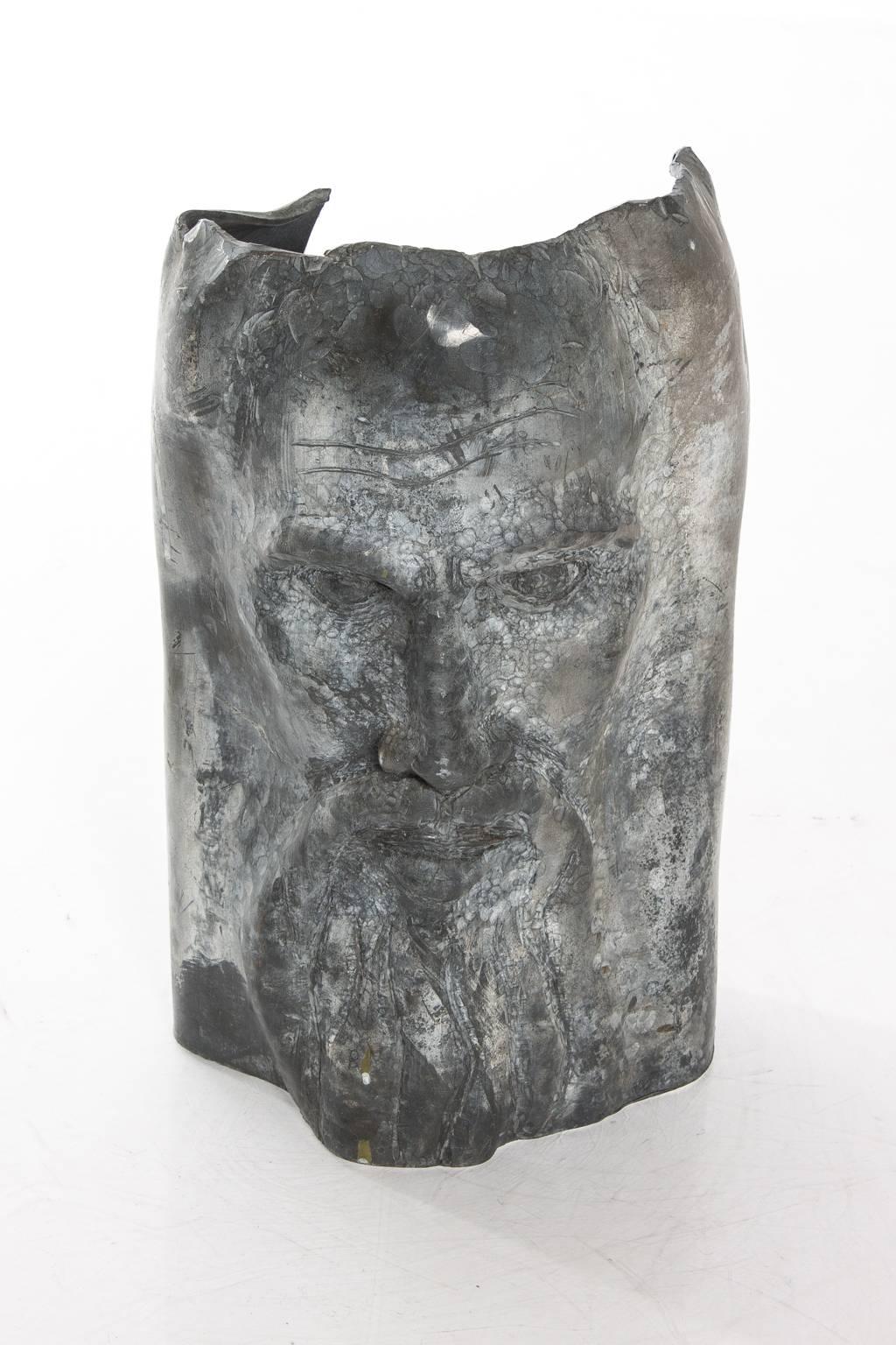 Contemporary sculpture of a bearded man.