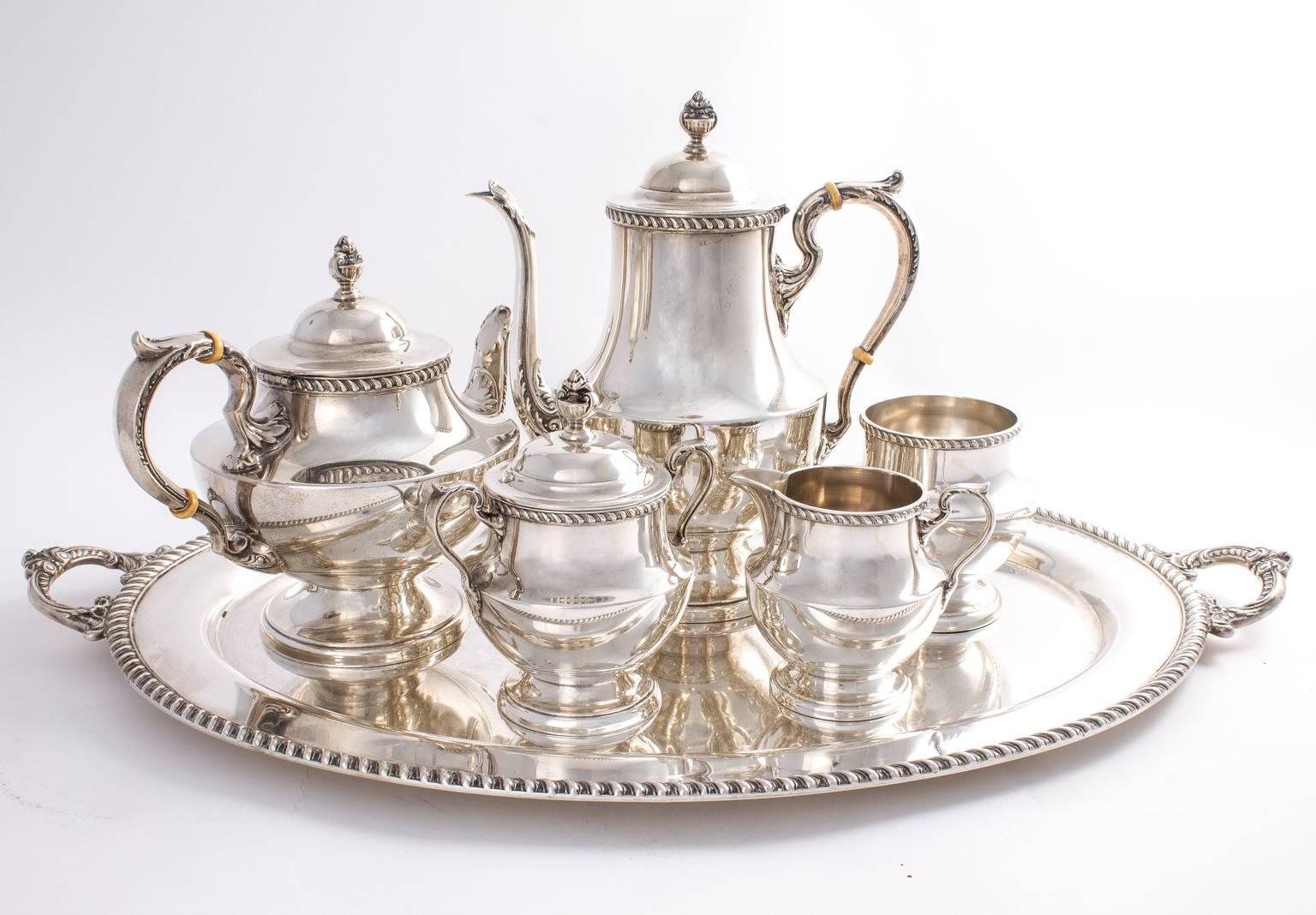 Poole sterling silver tea set. Six pieces, including: a Georgian tea and coffee pot, waste bowl, creamer, and sugar tray with gadroon trim. Approximately 170 oz.