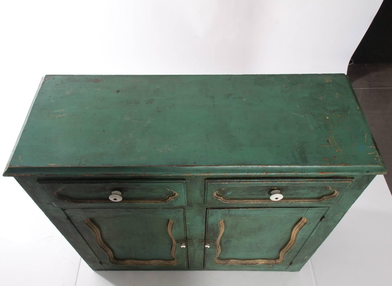 Antique painted two-drawer, two-door cupboard or cabinet with wide board shelving.