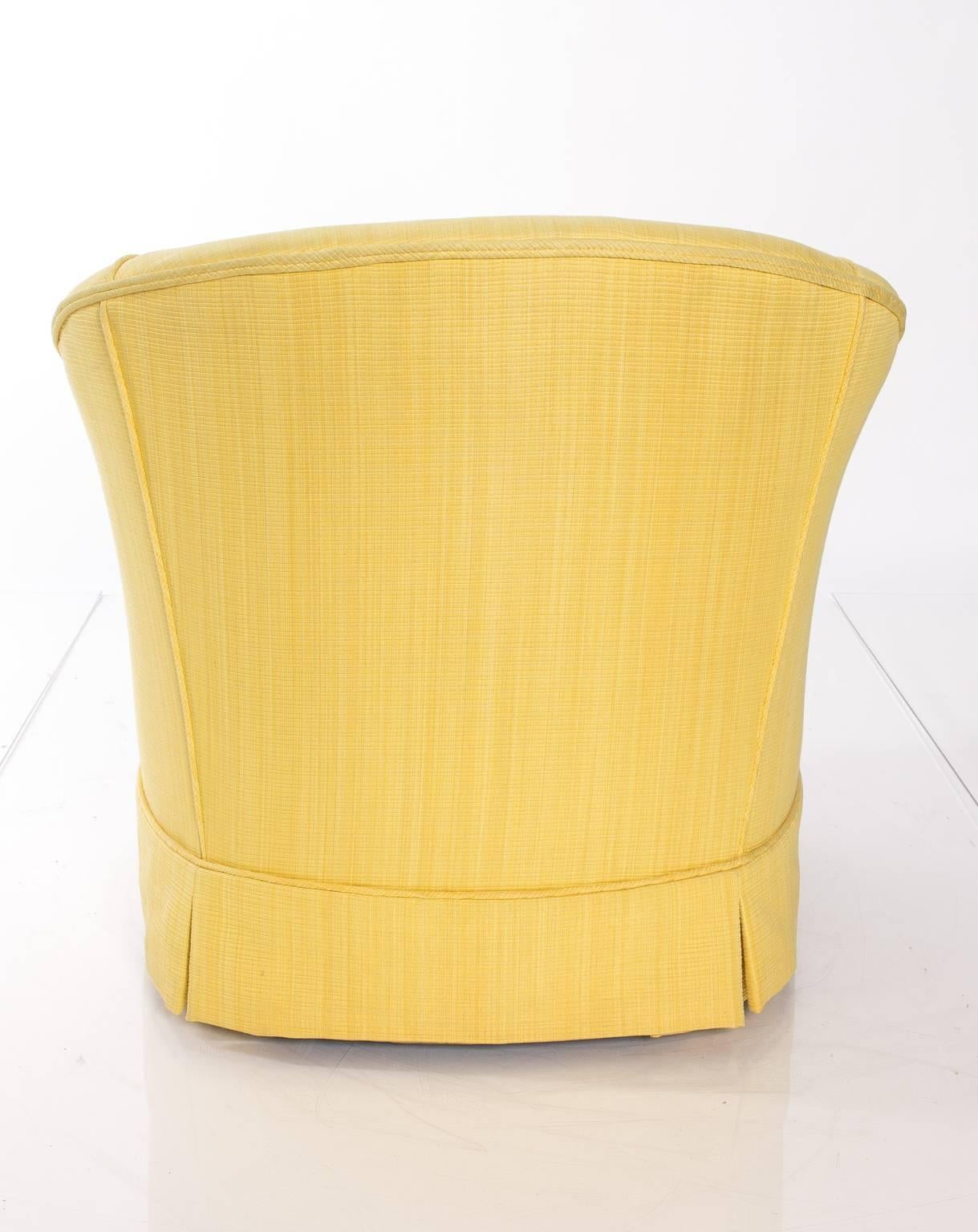 Pair of slipper chairs upholstered in a light yellow fabric.