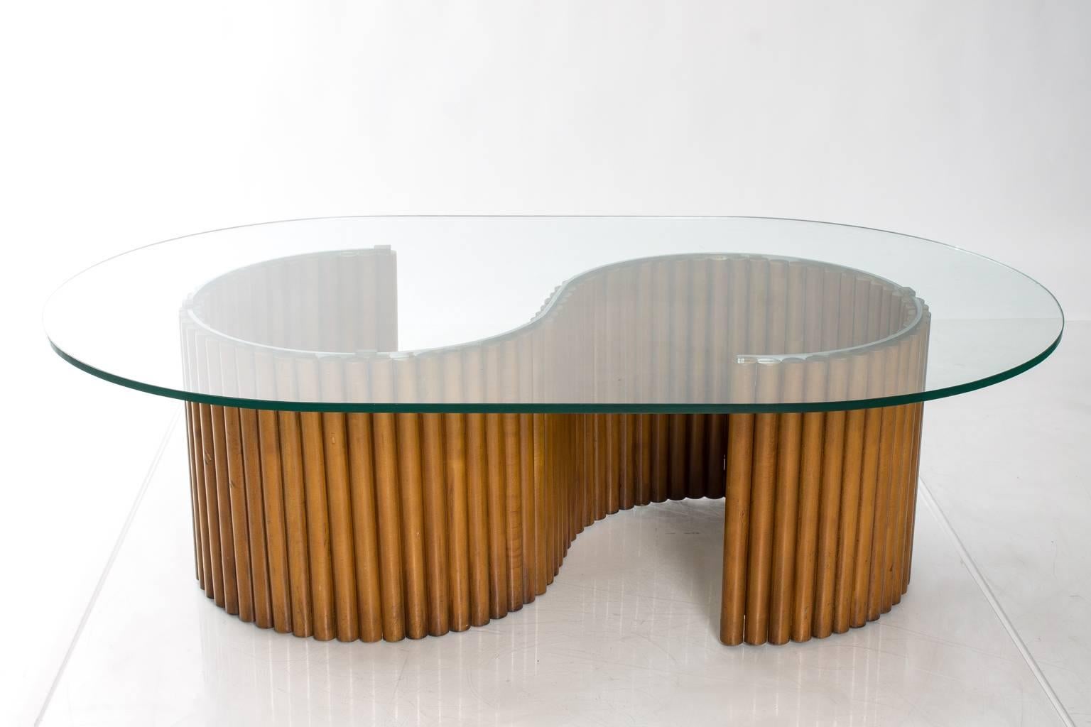 Contemporary S-curved table with bamboo base and custom glass top.
 