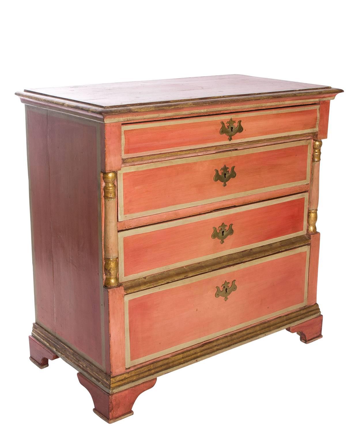 19th century Danish dresser in its original orange finish with gilded detailing. Dresser consists of four drawers with brass fittings.