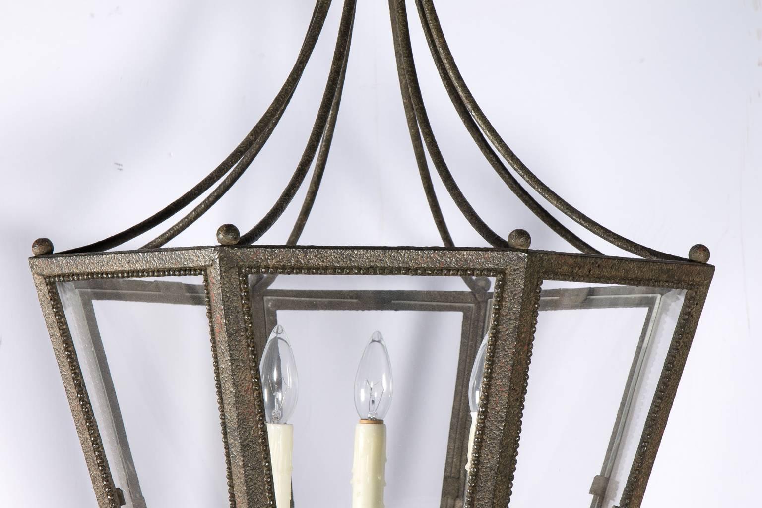 Neoclassical style patinated lantern with eight glass panels and three candle style lights, circa 2000. Made in USA.
   