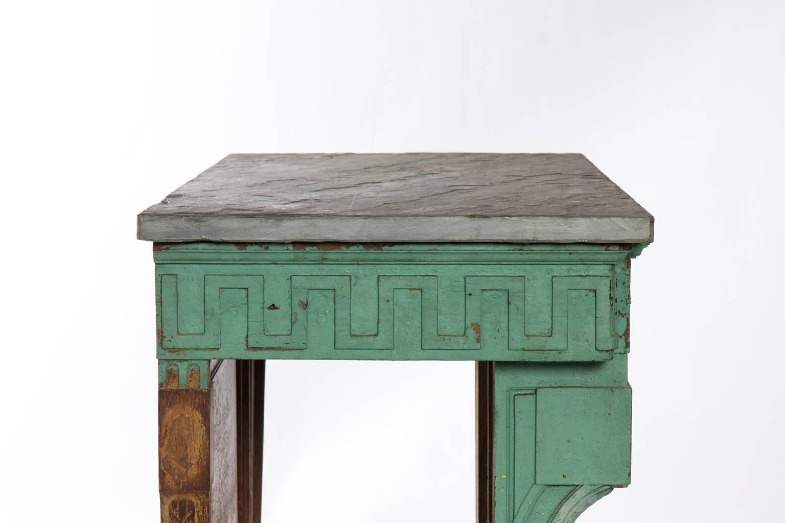 Green painted French Neoclassical style stone top garden console.
 