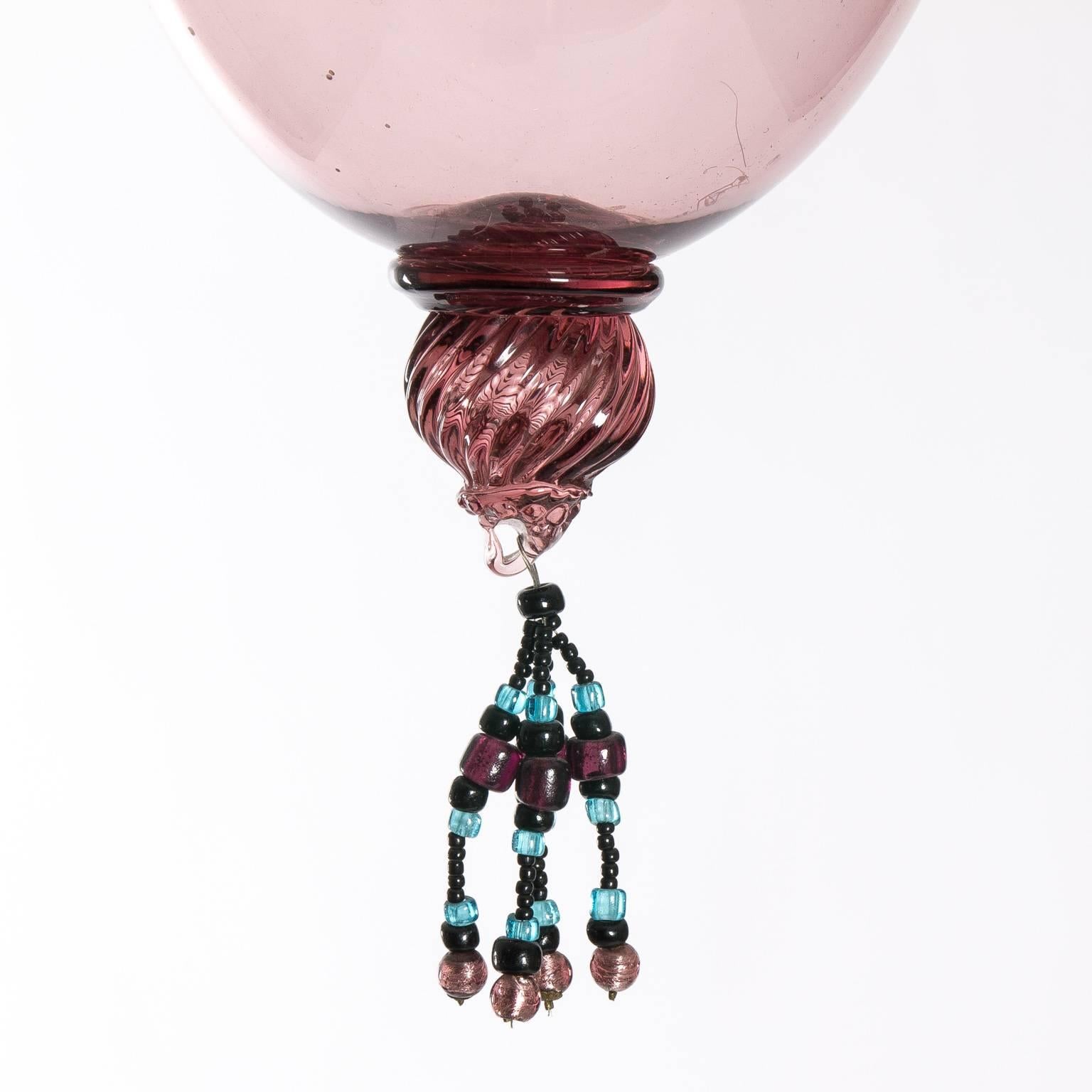 Mid-20th century handblown glass pendants in violet tinted glass with glass bead trim.
 