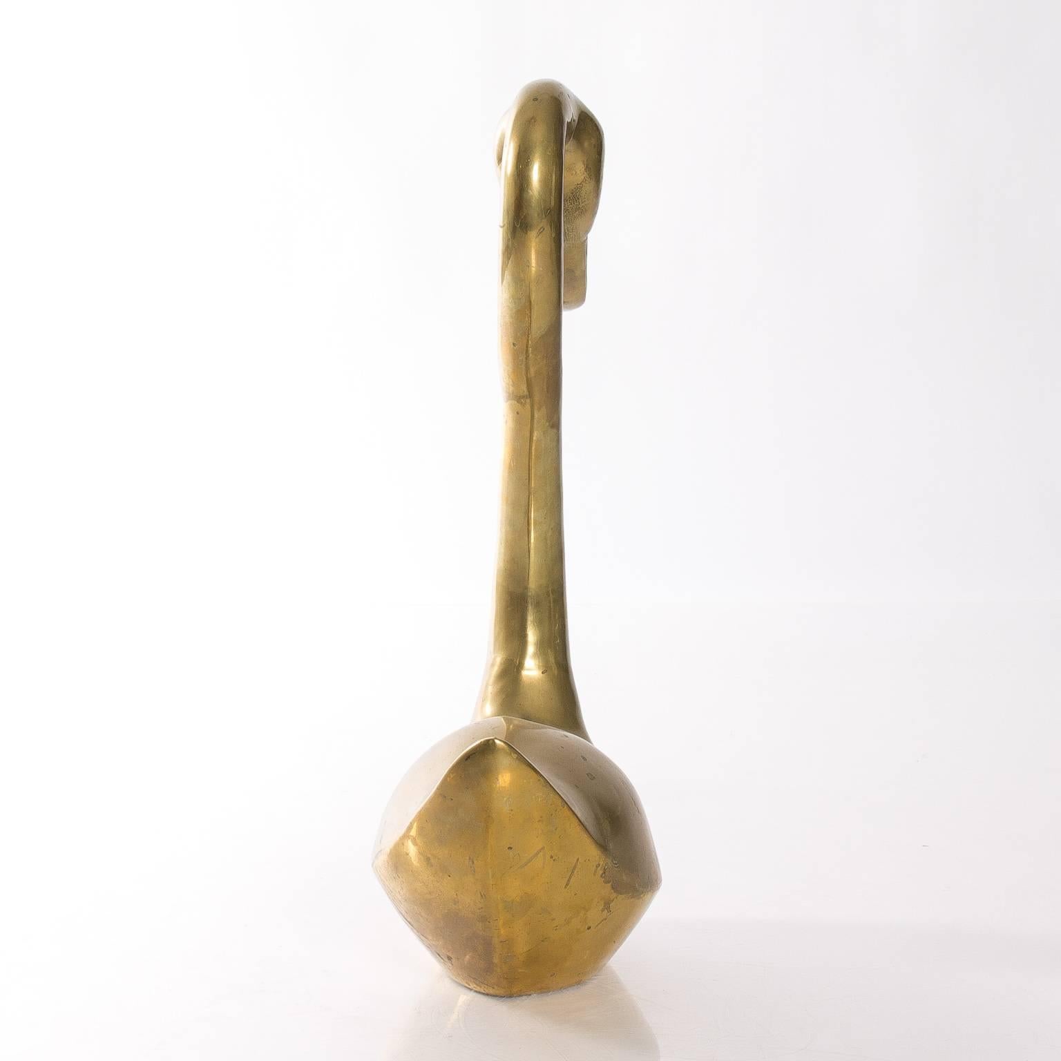 Pair of mid-20th century lifesize decorative brass geese. Measures: Large goose: 21 H x 26.5 H x 7 D. Small goose: 18 H x 22.5 D x 7 D.