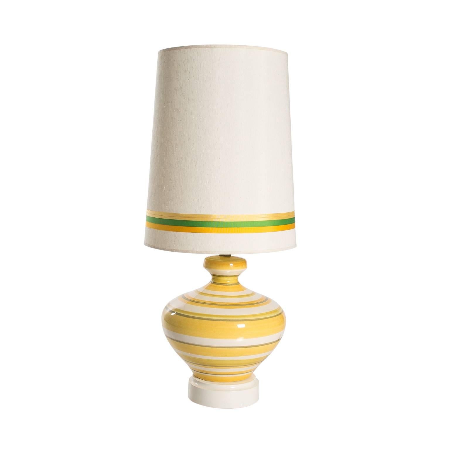 Pair of glazed ceramic yellow, white, and green striped table lamps with matching green and yellow shades.
 