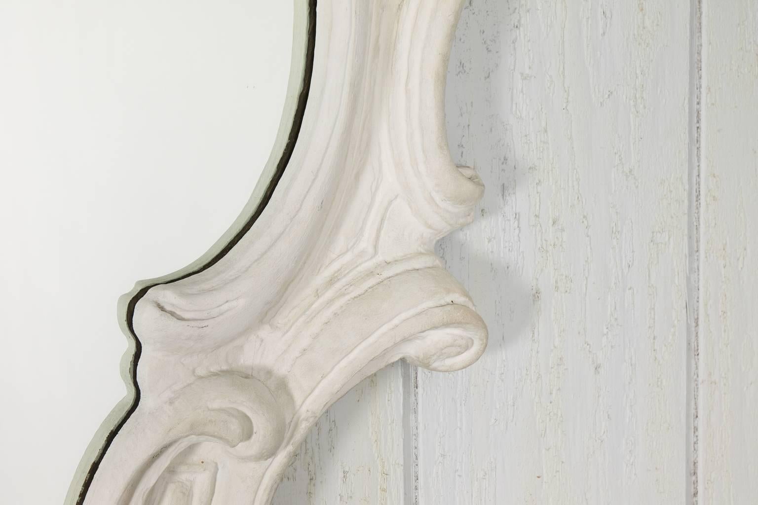1950s, Baroque style white plaster mirror with scrolled edges.
 