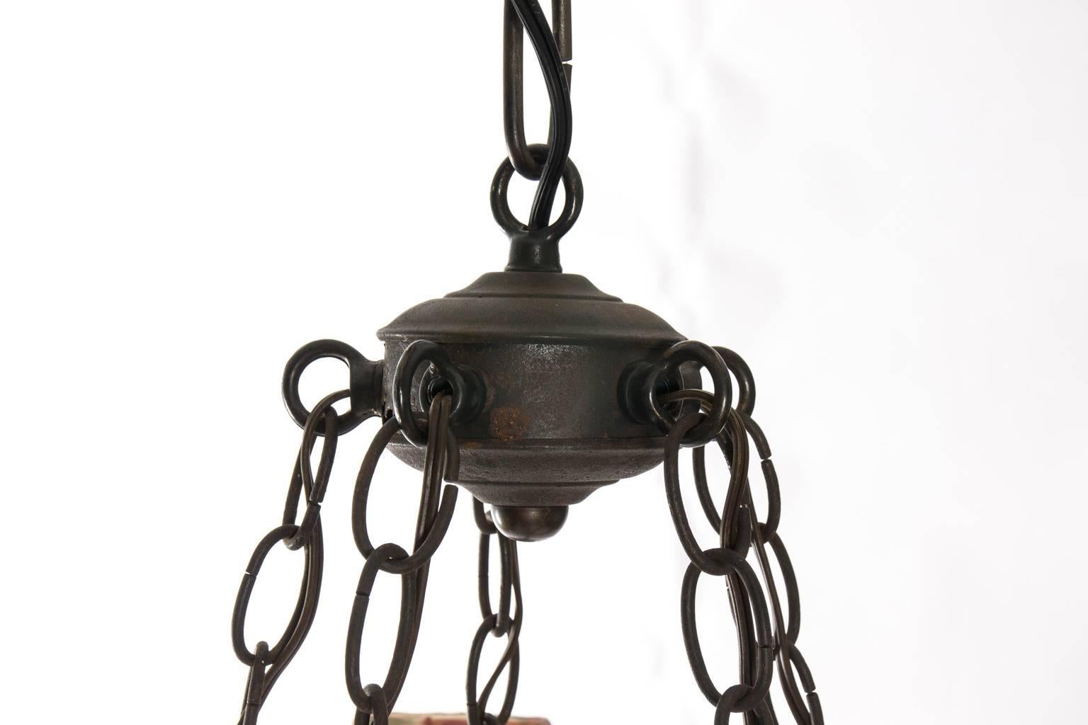 Gothic five-arm single-tier wrought iron chandelier with fortuny shades.
   