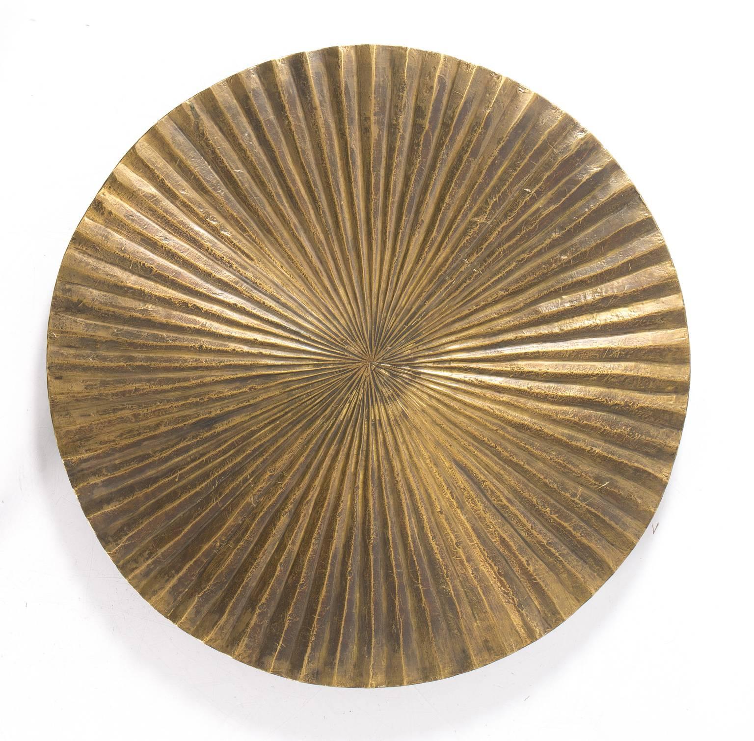 Three part wall hanging comprised of separate round overlapping ridged circles of various sizes.
   