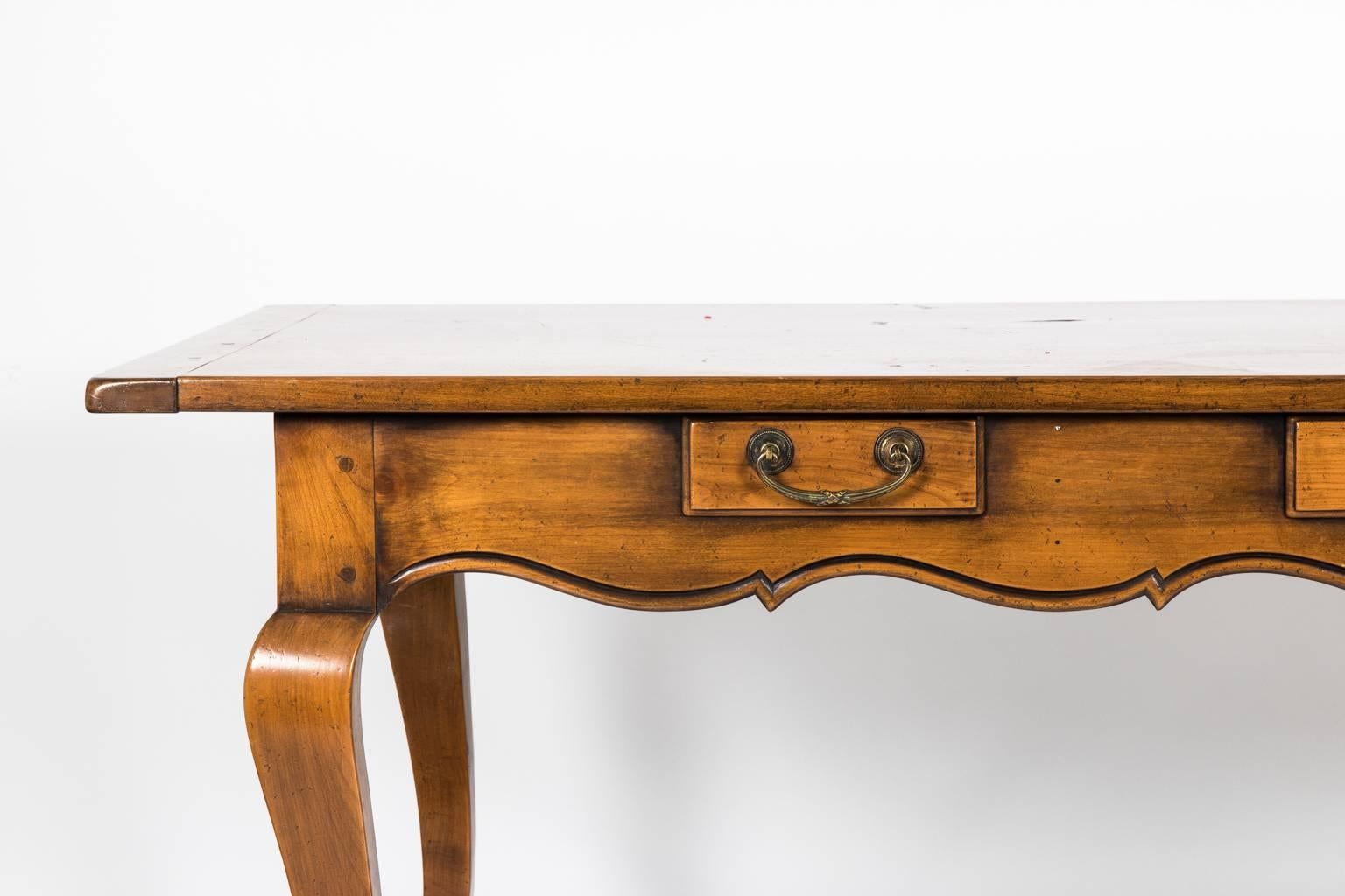 French Provincial style three-drawer walnut work table.
    
