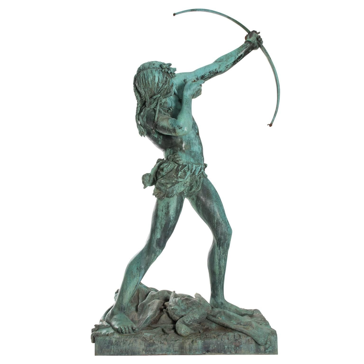 Bronze statue of a young Native American hunter aiming from his bow.
 