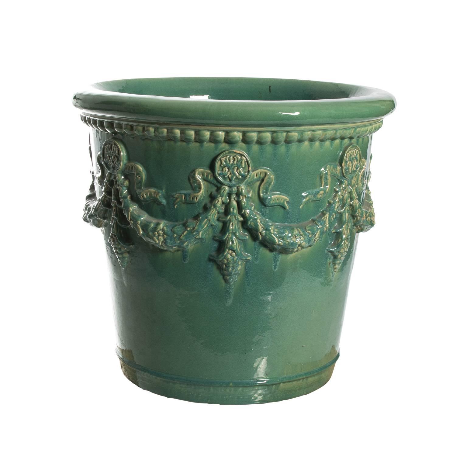 Pair of mid-20th century large ceramic glazed planter in light green hue.
 