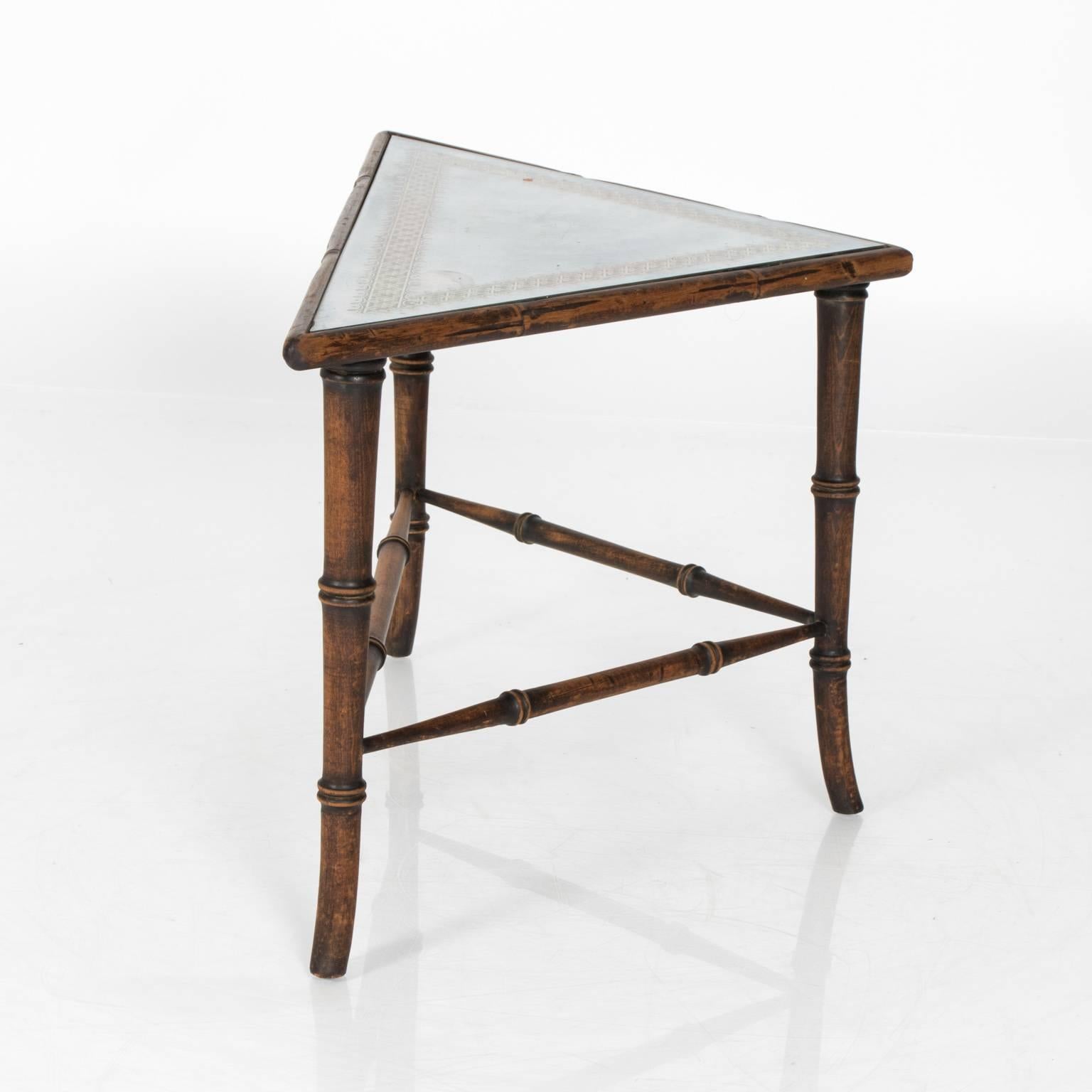 Pair of early 20th century English triangular bamboo side tables with etched mirrored tops.
 