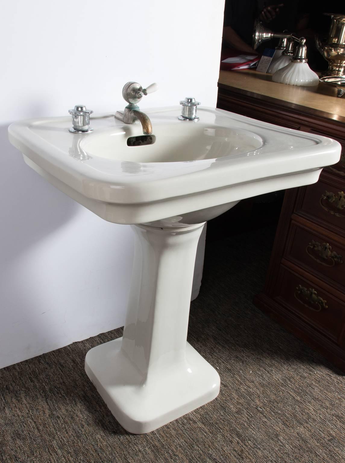 Small sized pedestal sink with replaced valves and original mixer, circa 1910.
 