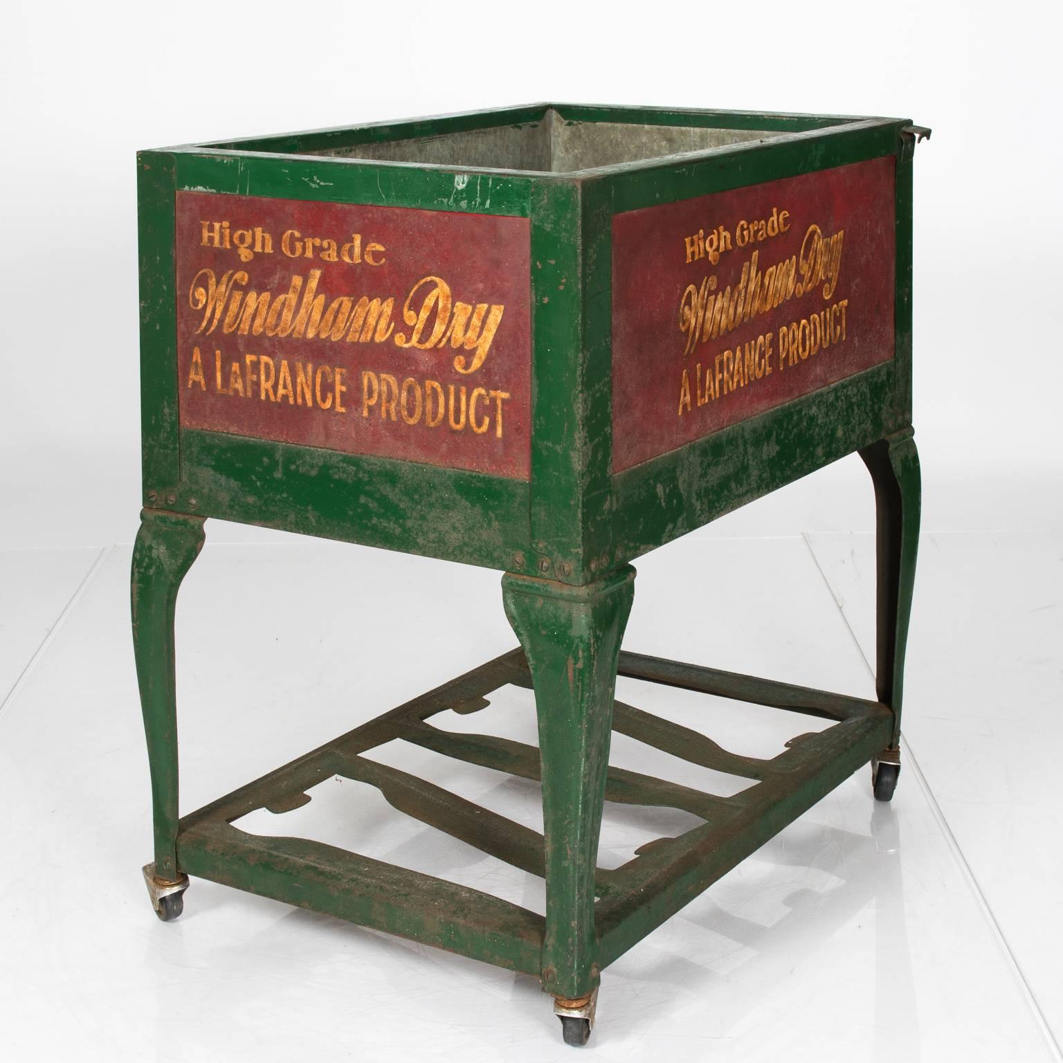 Vintage ice chest on wheels with advertising featured on the sides, circa early to mid-1900s.
 