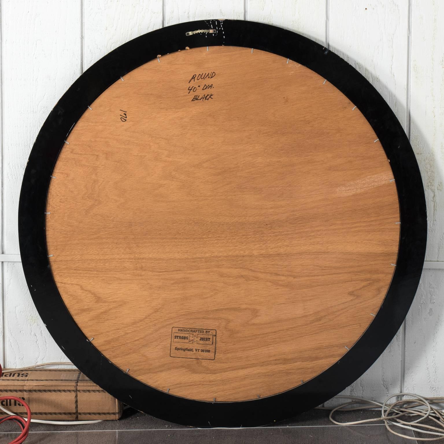 Mid-Century Modern round black lacquered mirror, circa 1970.
 