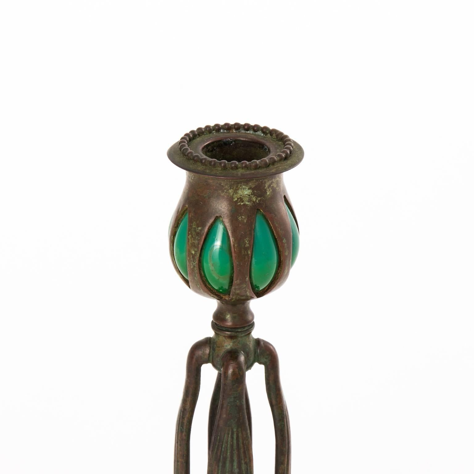 Tiffany Studio four-leg candleholder with green blown glass and lion's paw feet, circa late 19th century.
 