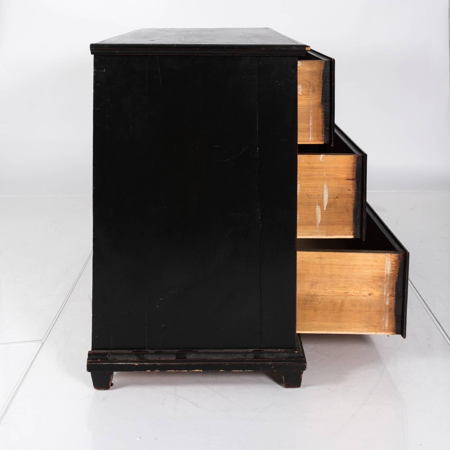 Black three-drawer chest, circa late 19th century.
 