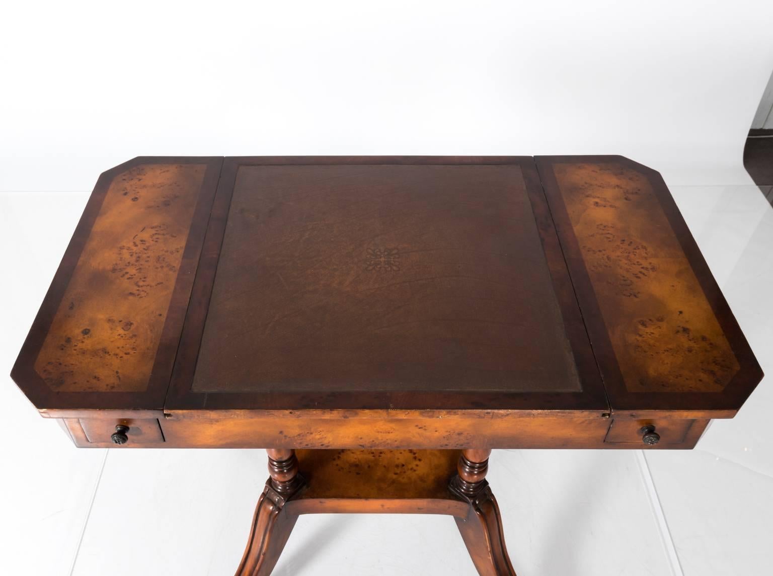 Four-drawer wooden game table that converts to a leather writing desk, circa 1940.
