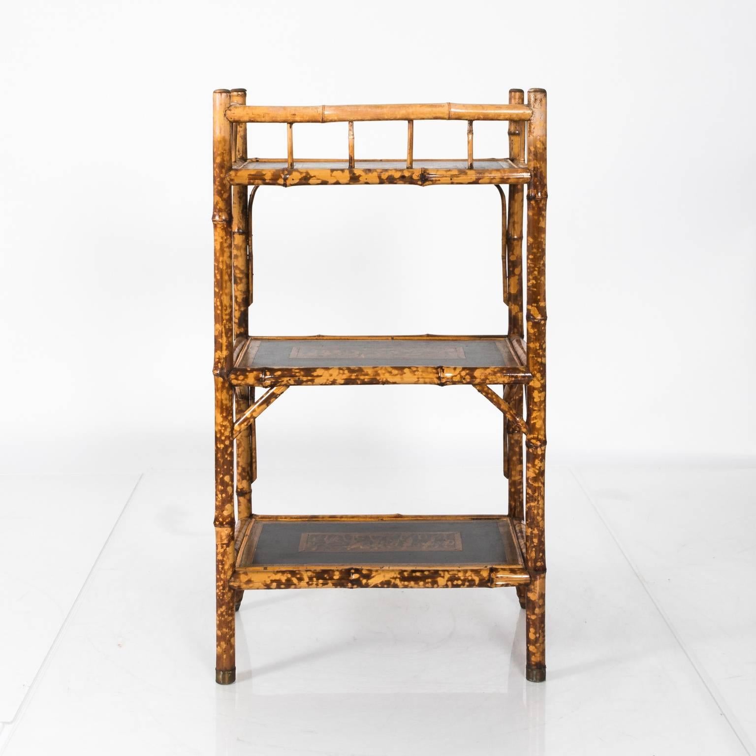 Bamboo Étagère with three black shelves featuring various Roman warfare scenes framed by guilloche trim, circa 1940.