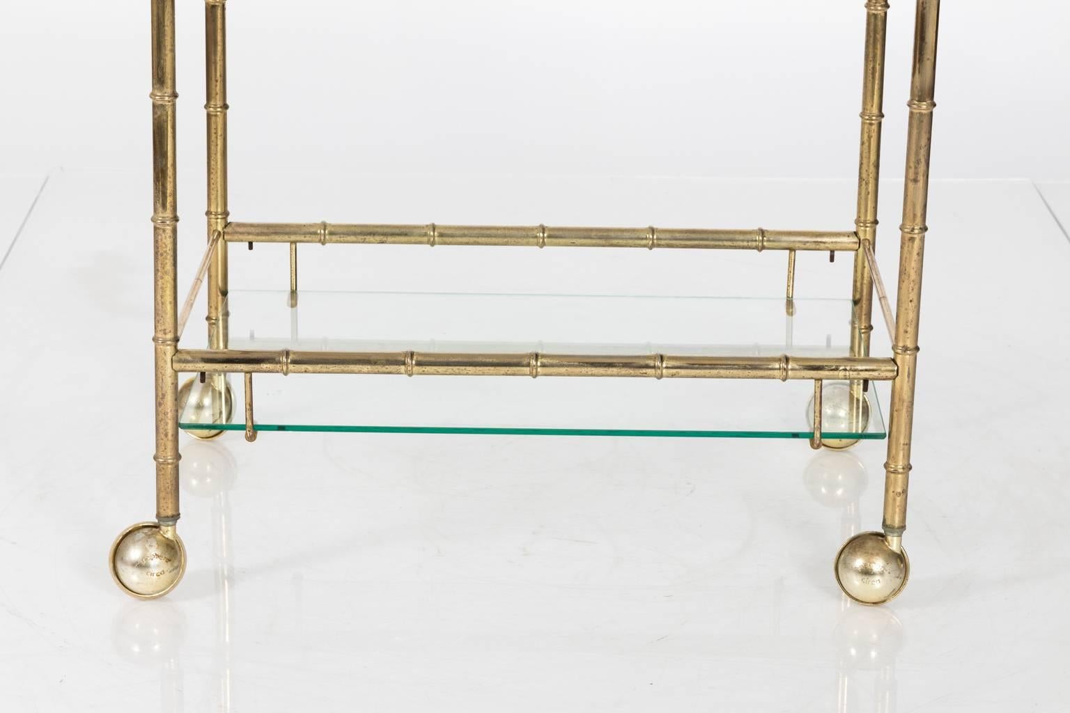 Brass faux bamboo bar cart, circa mid-20th century.
 