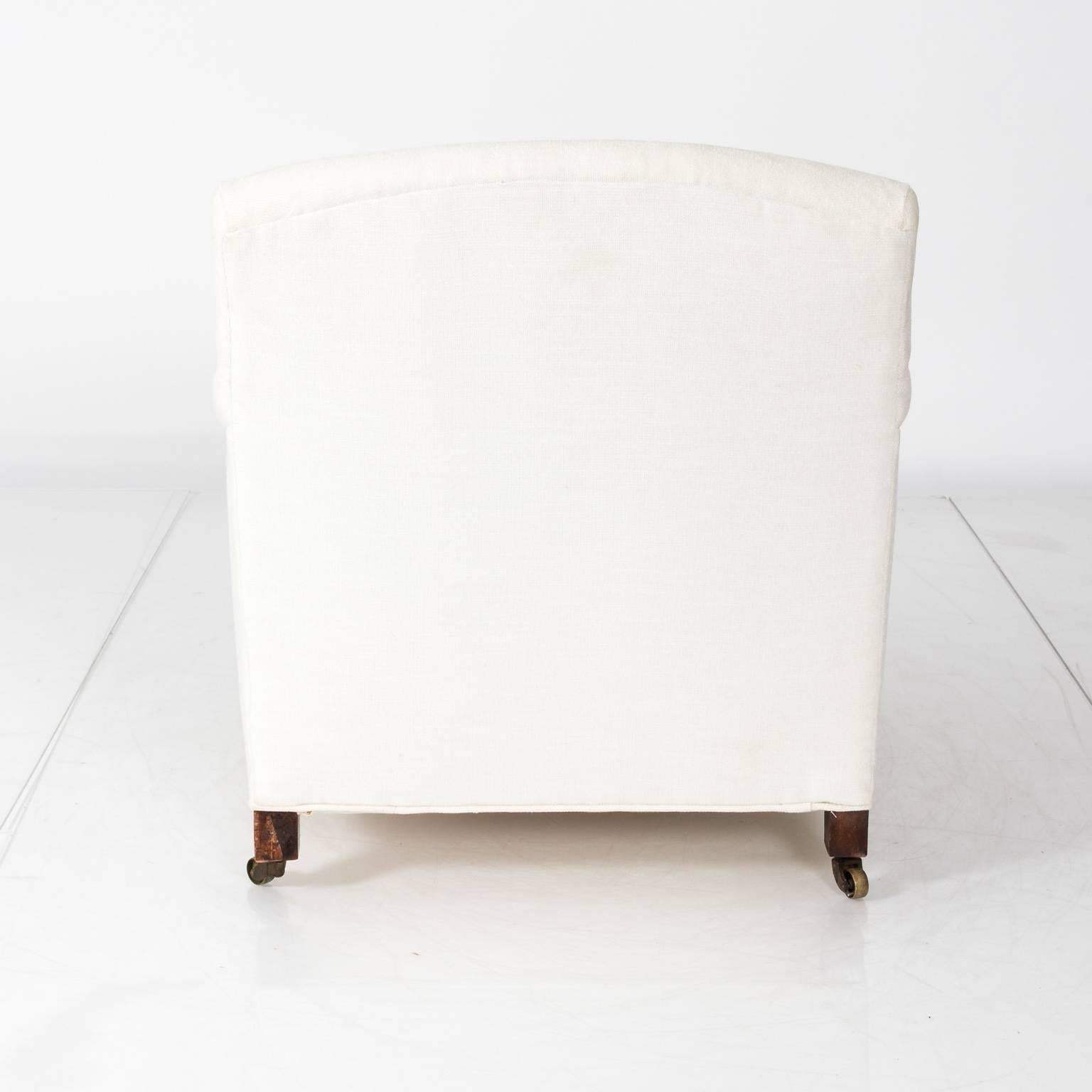 Pair of vintage club chairs in a white fabric, circa 1930.
    