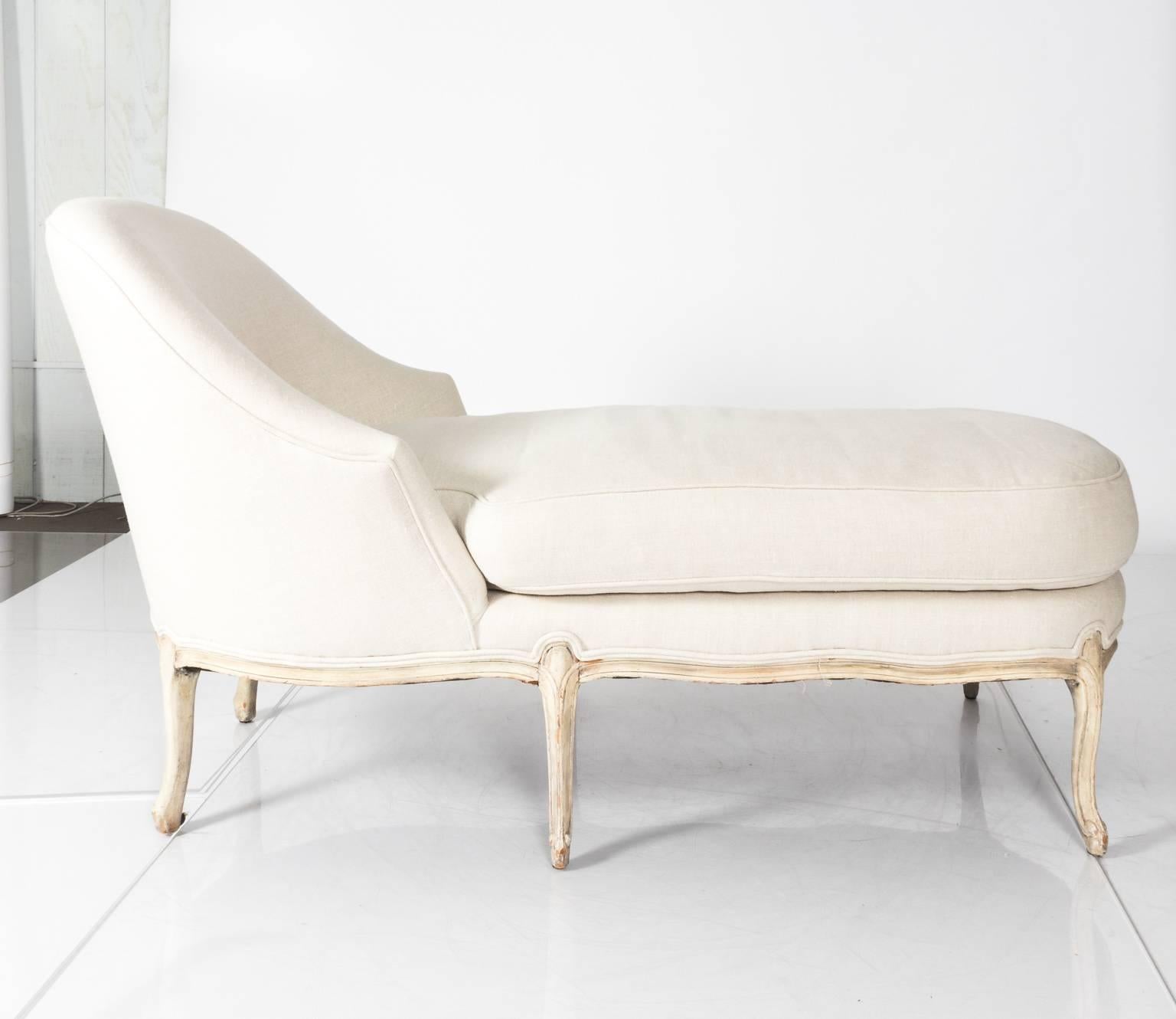 Louis XV style linen upholstered chaise longue, circa 1920.
    