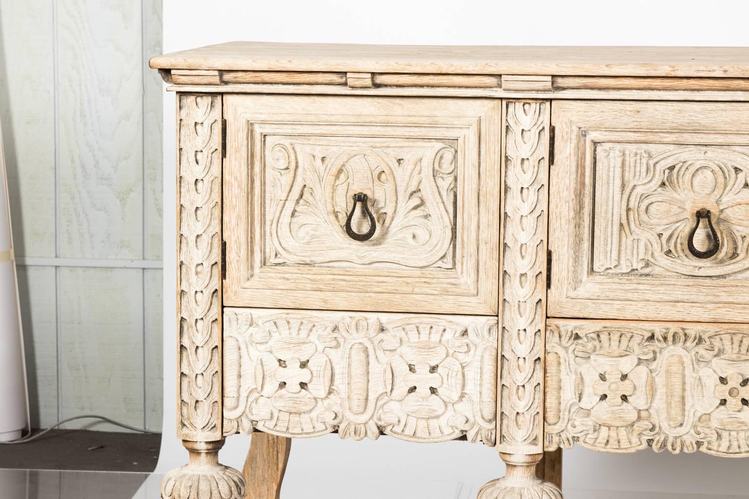 Tudor style long sideboard of bleached oak with four drawers, circa 1900.
 