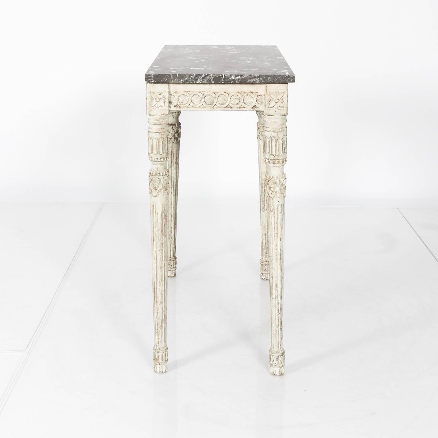 Pair of 19th century, white-painted Gustavian console tables with grey marble tops.
     