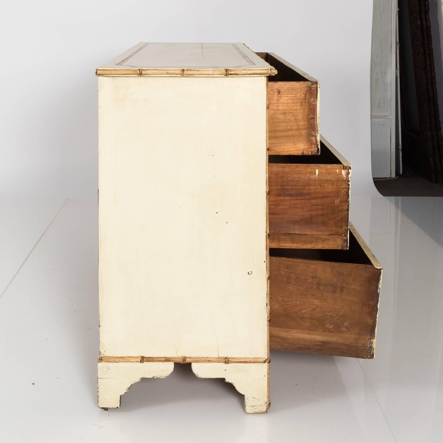 White painted chest with faux bamboo, circa early 20th-century.
  