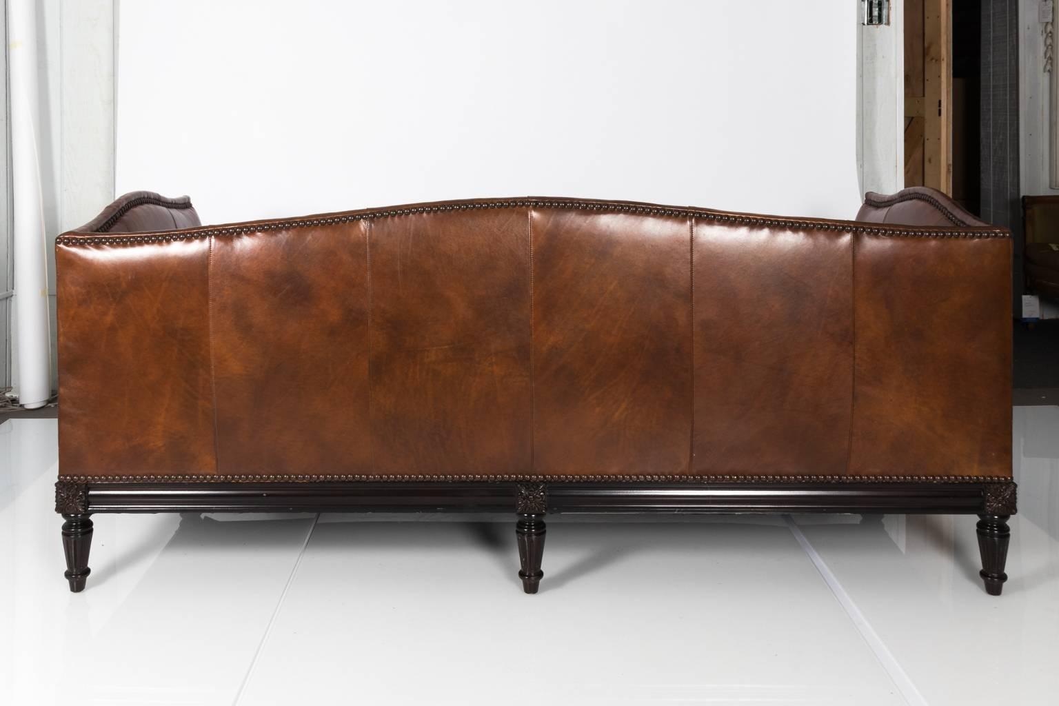 Contemporary brown leather camelback sofa by Sherrill Furniture with nailhead trim.
   