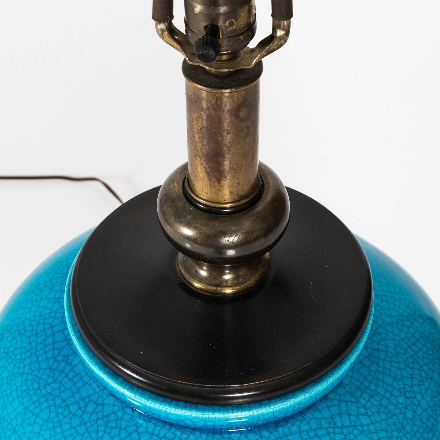 Table lamp with a blue painted base in a crackle finish. Shade included, circa mid-20th century.
    