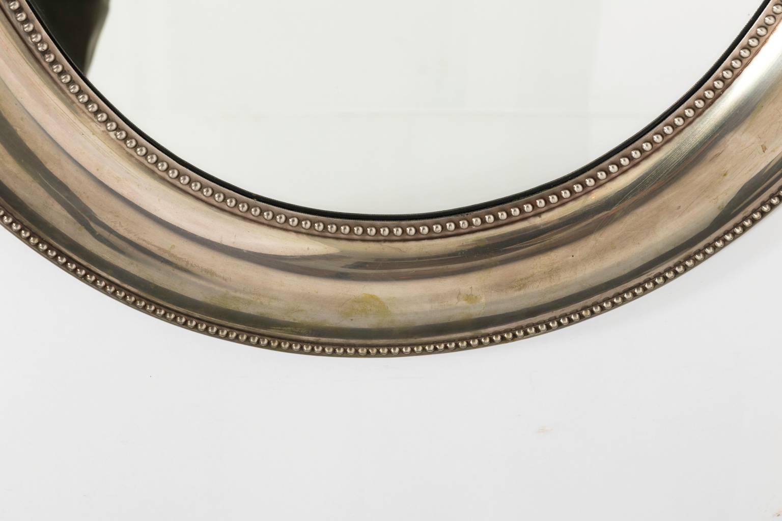 Contemporary set of two silver plated oval mirrors in a glossy finish.