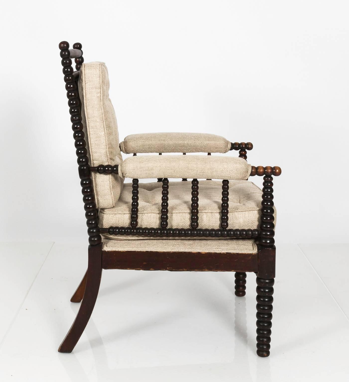 English Mahogany Bobbin chair from the UK that features custom upholstery and ball turnings, circa early 20th century.