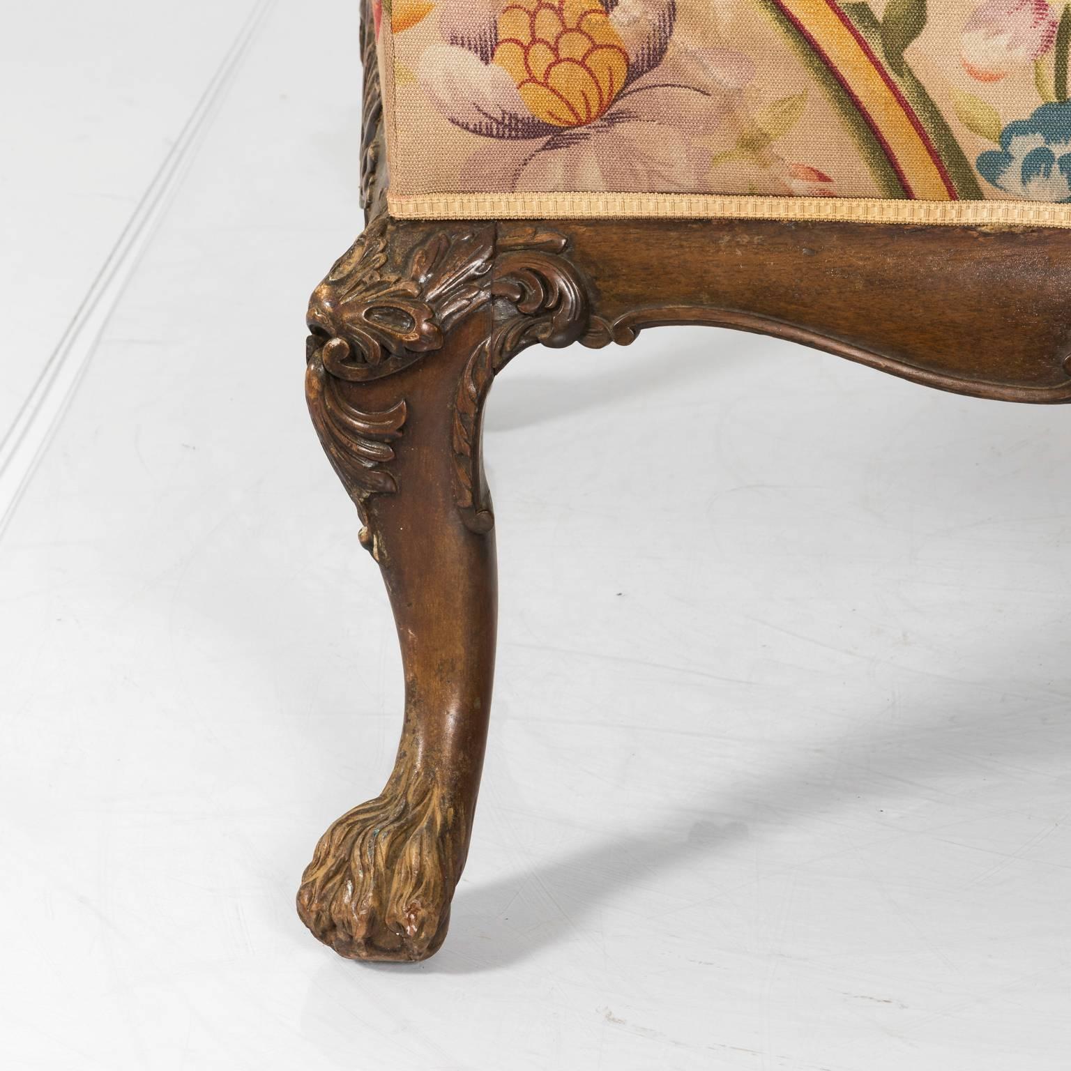 Late 19th century Chippendale style arm chair with curved back armrests and claw feet.
